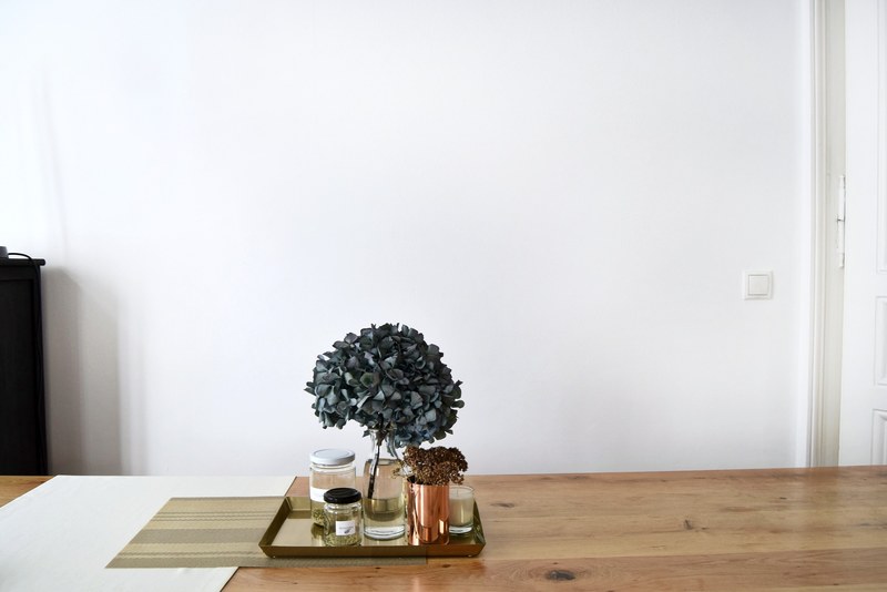 pale blue hydrangea flowers in a vase next to a scented candle and jars, hydrangea in a vase 4k
