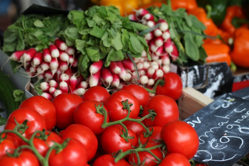 radishes and vine ripened tomatoes at a vegetable stand, veggies for sale 4k