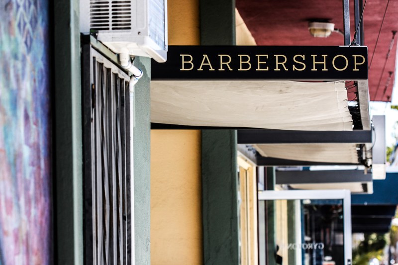 a barber shop signpost at a storefront, barber shop sign 4k