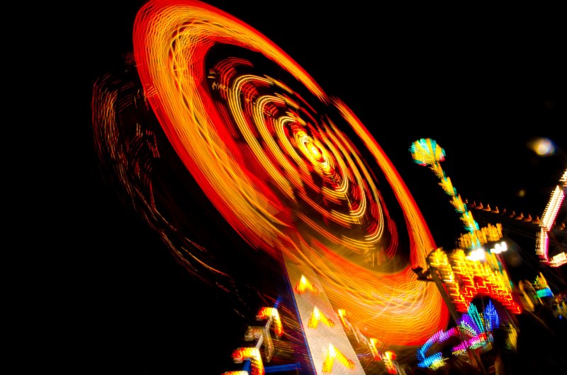 a lively shot of an illuminated ferris wheel at the fairground in ocean city, at night 4k