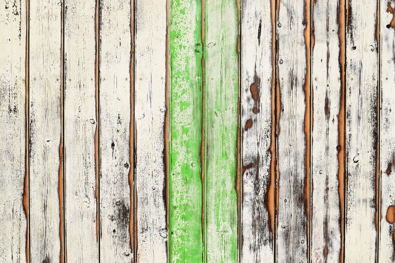 a worn out wooden deck with two green slats in the middle, partially green wooden deck 4k