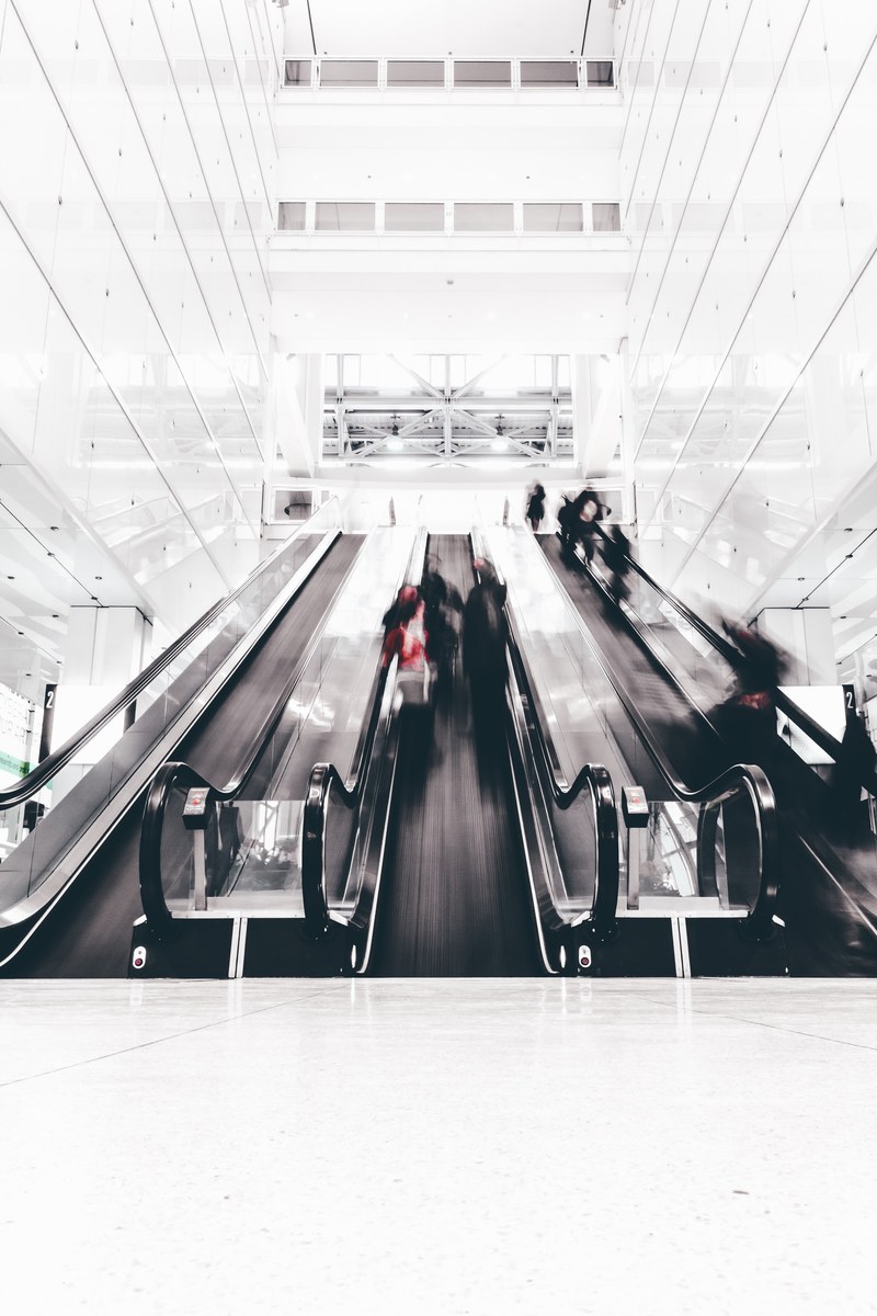 a time exposure shot capturing people using an escalator in a chicago building, escalation 4k