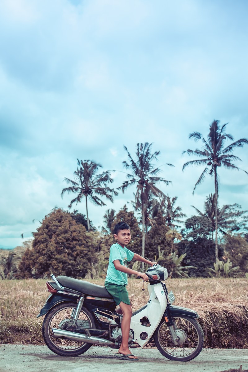 small balinese boy on motorbike 4k