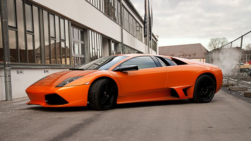 lamborghini, murcielago, lp640, orange, side view, black wheels, building, windows, fence, sky, clouds, 4k