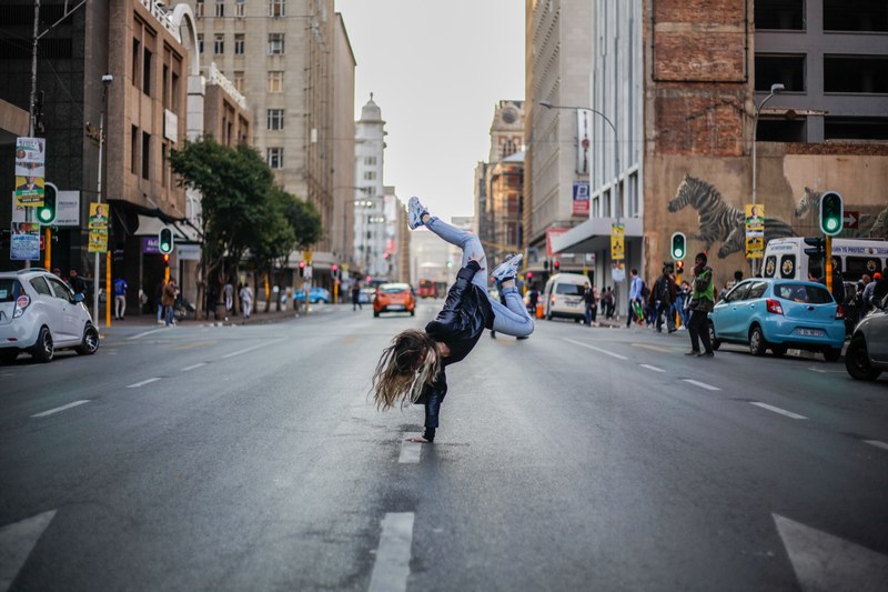 a woman doing a single handed handstand in the middle of the street, _dance 4k