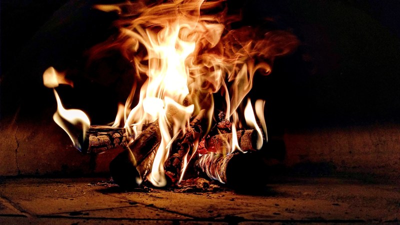 flames burn logs in a hot fireplace, fire 4k