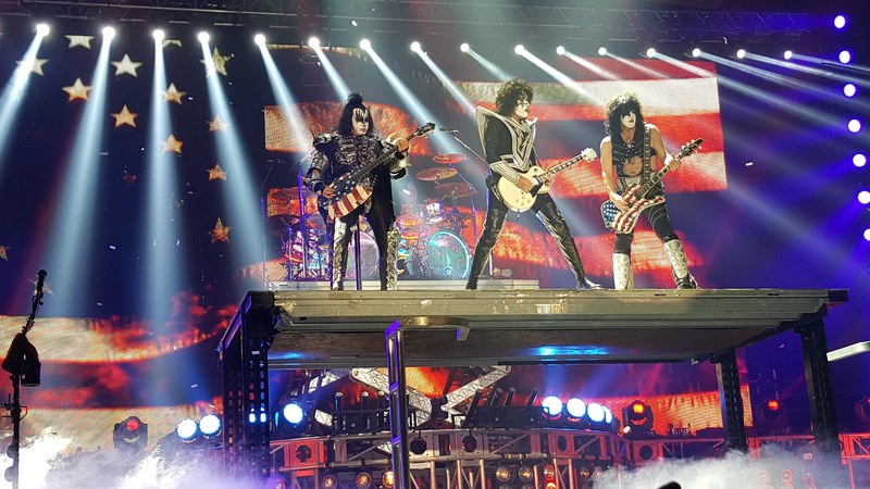 the band kiss wearing stage make up performing in front of a large american flag displayed on a screen, kiss at huntington center toledo ohio 2016 4k