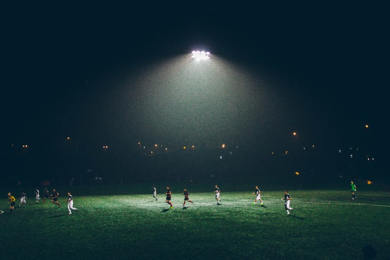 a soccer game being played at night under floodlights, soccer at night 4k