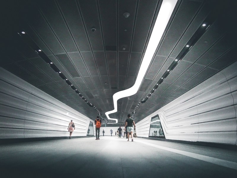 an underground passage with futuristic panelling on the walls, wynyard station pedestrian tunnel 4k