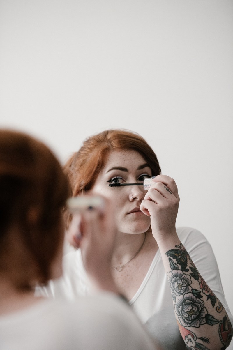 woman applying mascara make up 4k