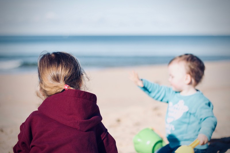 child playing in the sand on the culburra beach, playing on the beach 4k
