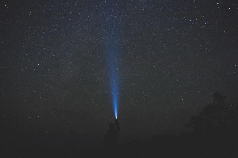 a man shines a flashlight into the starry night sky at samuel de champlain provincial park, _stars samuel de champlain park 4k