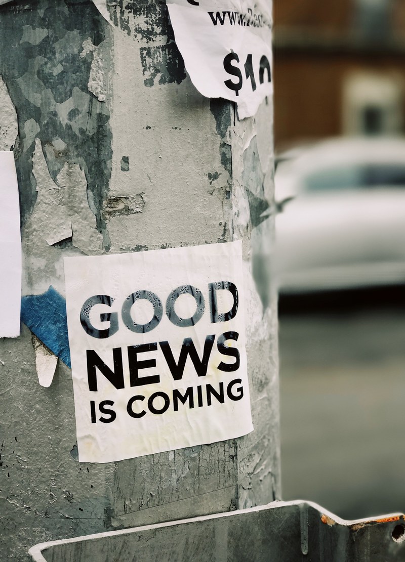 a sticker reading good news is coming on an advertising column, good news is coming 4k