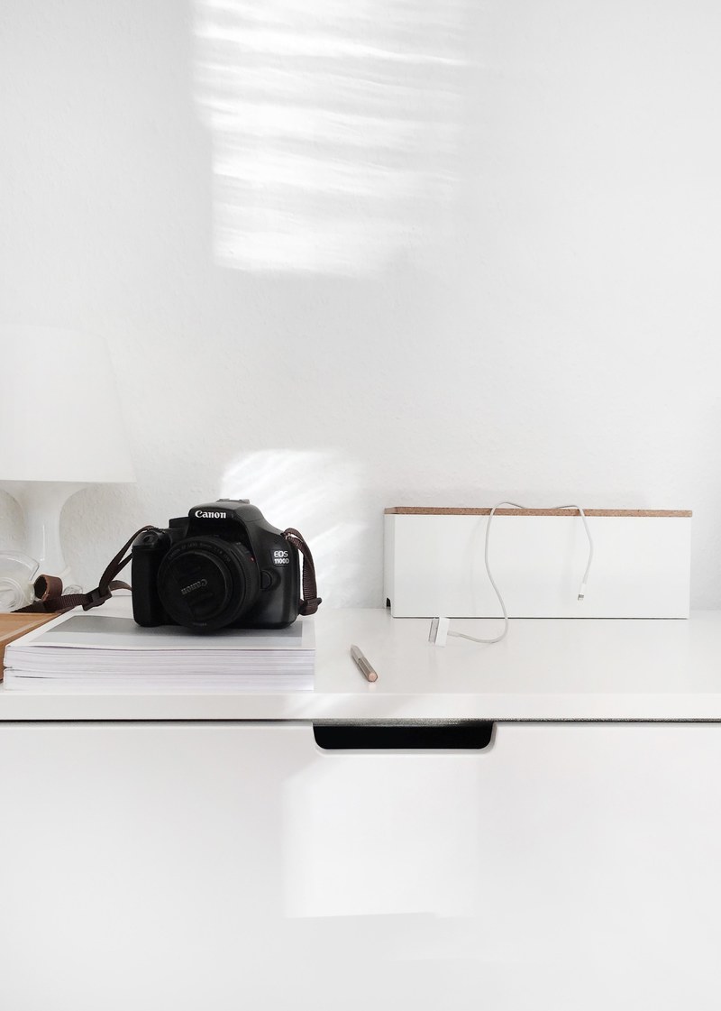 a camera sitting on a white desk, _camera on desk 4k