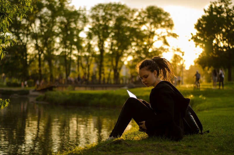 student sitting by water woman and studying 4k