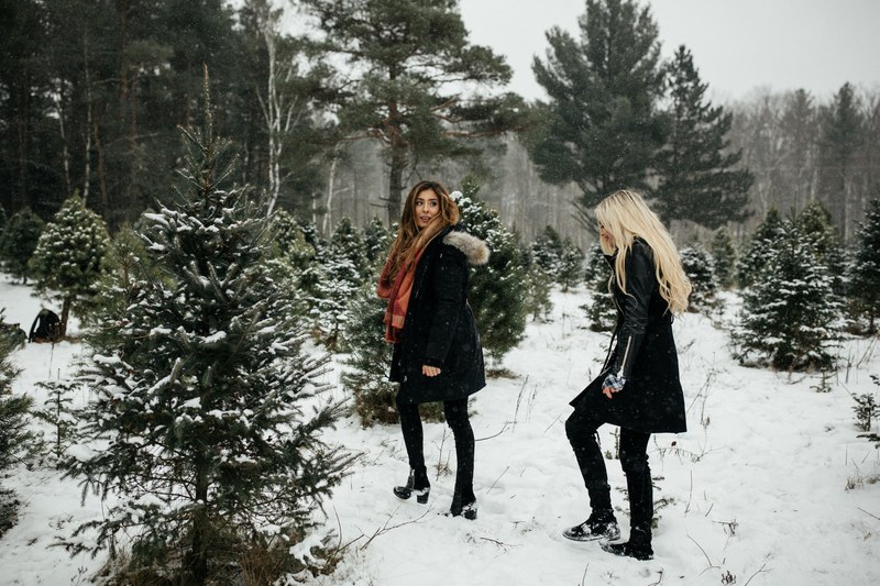 christmas woman walk through snow and xmas trees 4k