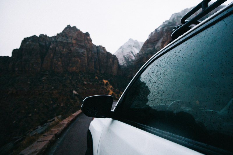 white vehicle driving down a mountain road in a drivers side pov, _car mountain road 4k
