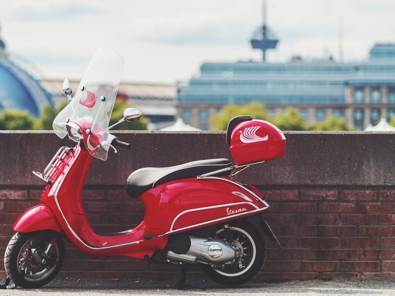 red moped parked on a bridge overpass in the city, scooter in the city 4k