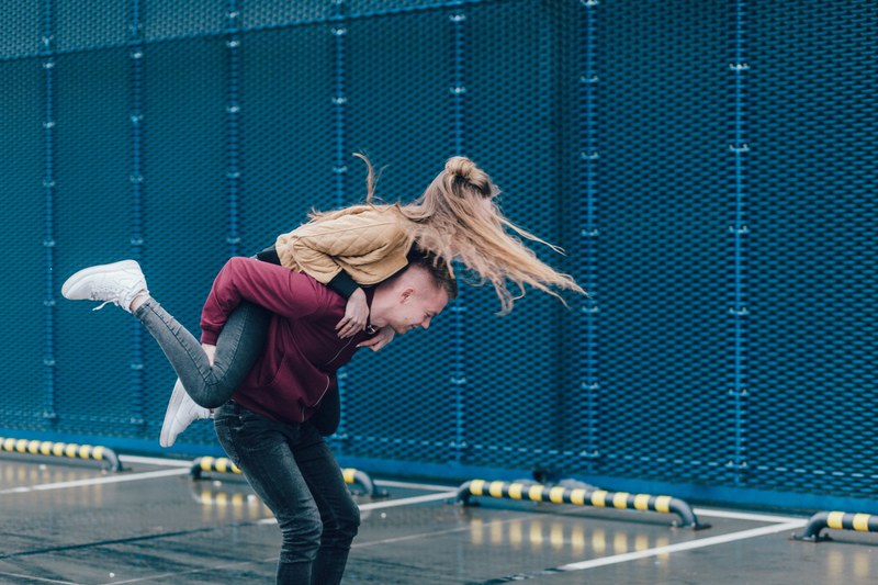 happy young couple playfully jumping on each others back, happy couple 4k