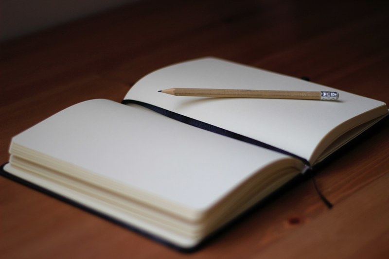 a pencil on the blank pages of an open notebook, tabel day 4k