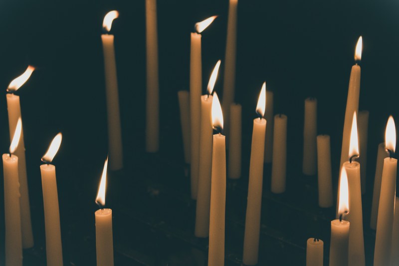 tall candlesticks burning besides shorter unlit candlesticks in the dark, tall candlesticks 4k