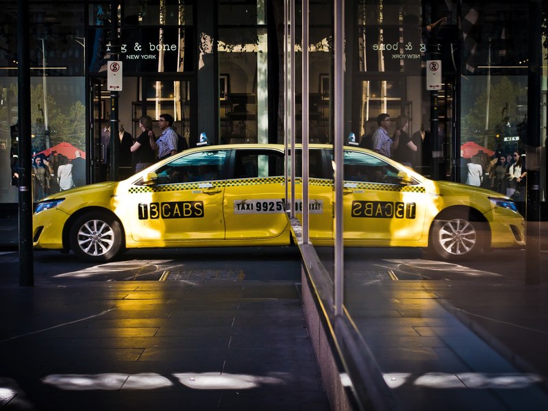 reflection of the damaged yellow cab in the shop windows in little bourke street, yellow cab reflection in shop windows 4k