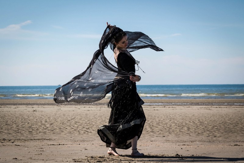 woman in black dancing on the sand beach at de panne, woman dancing on the beach 4k