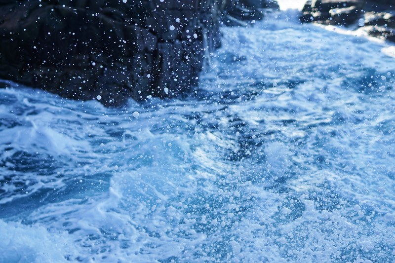 splashing water near jagged rocks, splashing water and rocks 4k