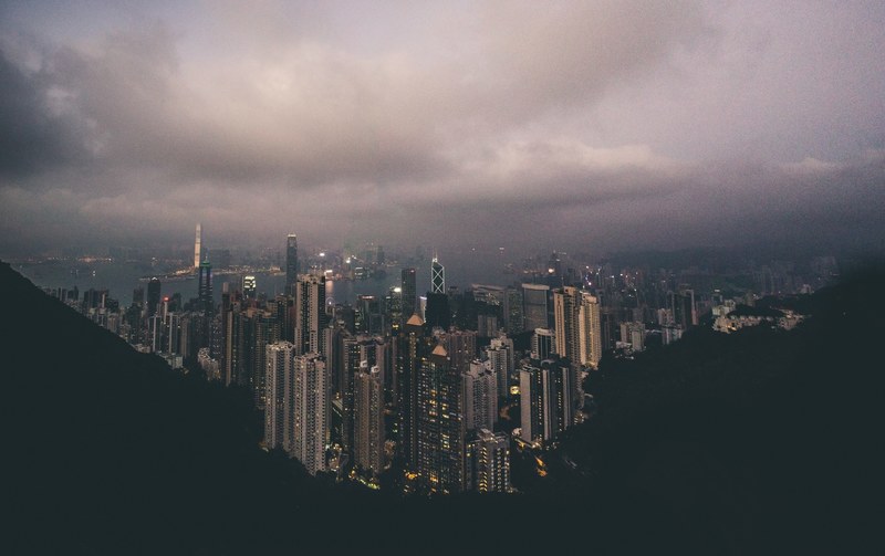 a cityscape under thick gray clouds, hong kong viewpoint 4k
