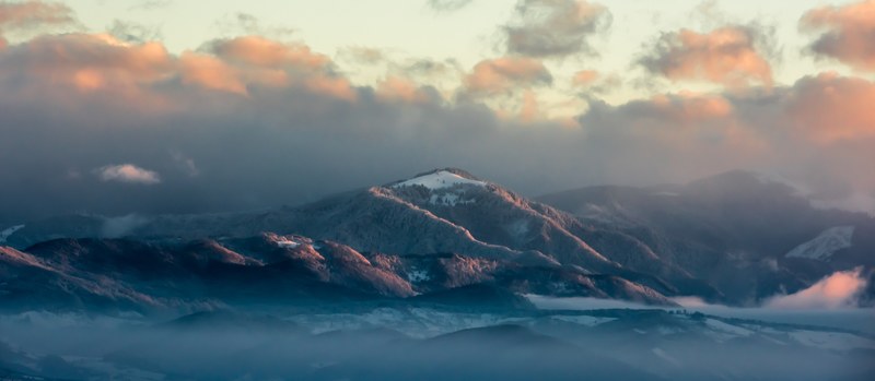a landscape view of a mountain under overcast sky in maramure county romania, mara 4k