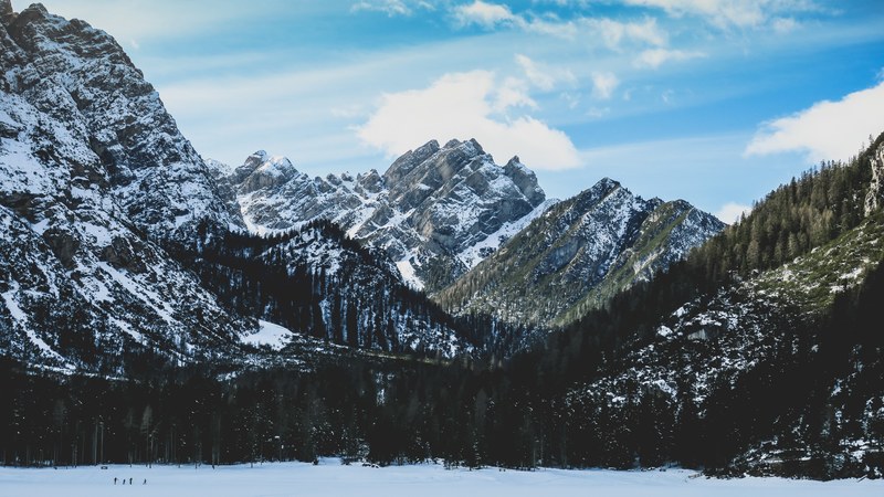 a wintry scenery with craggy mountain crests and wooded slopes near lago di braies, day 12 unsplashdaily 4k