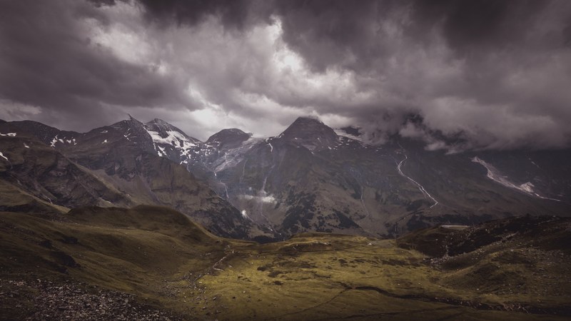 a snow topped mountain massif under dense clouds, find waldo find the cows edition 4k