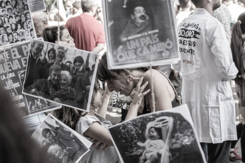 a mother speaks to her daughter in a crowd full of protest signs in buenos aires, madres mothers 4k