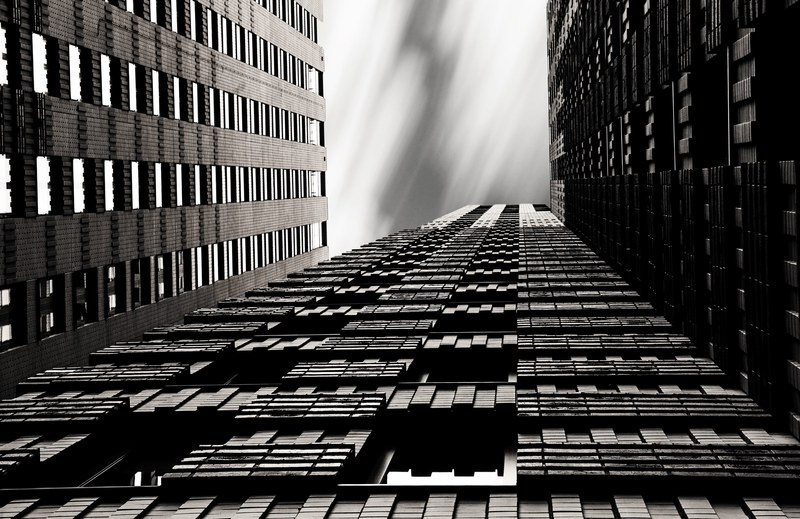 a black and white shot of skyscrapers with geometric patterns facade, _city skyscraper architecture 4k