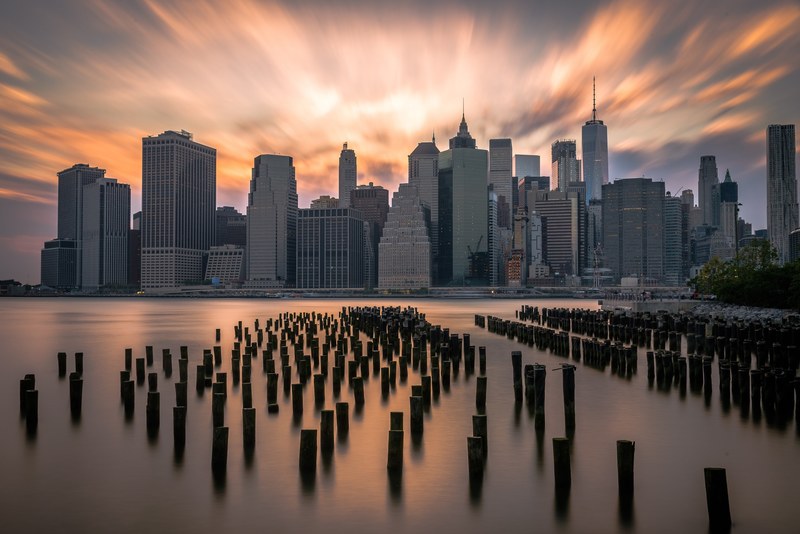 new york city from the hudson river with the skyline and freedom tower in the background during sunset, best city in the world 4k
