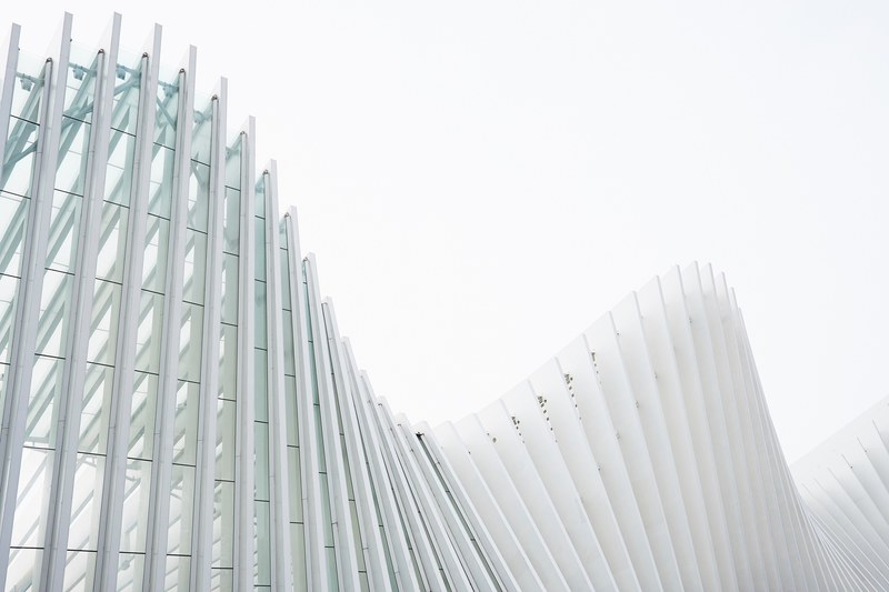white concrete ribs in the undulating glass facade of a modern building, concrete ribs in a facade 4k