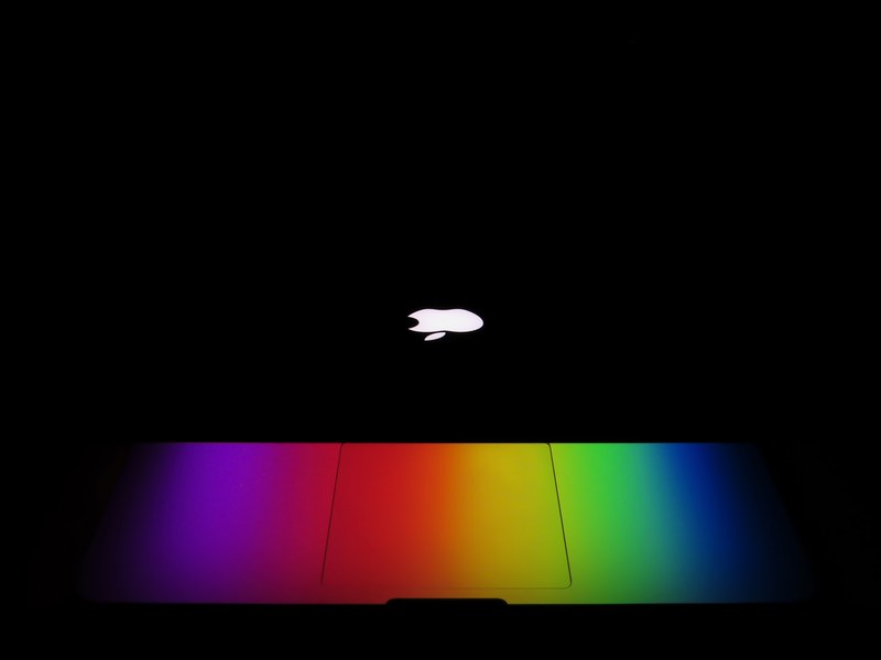 a macbook computer glowing rainbow color, rainbow color macbook 4k