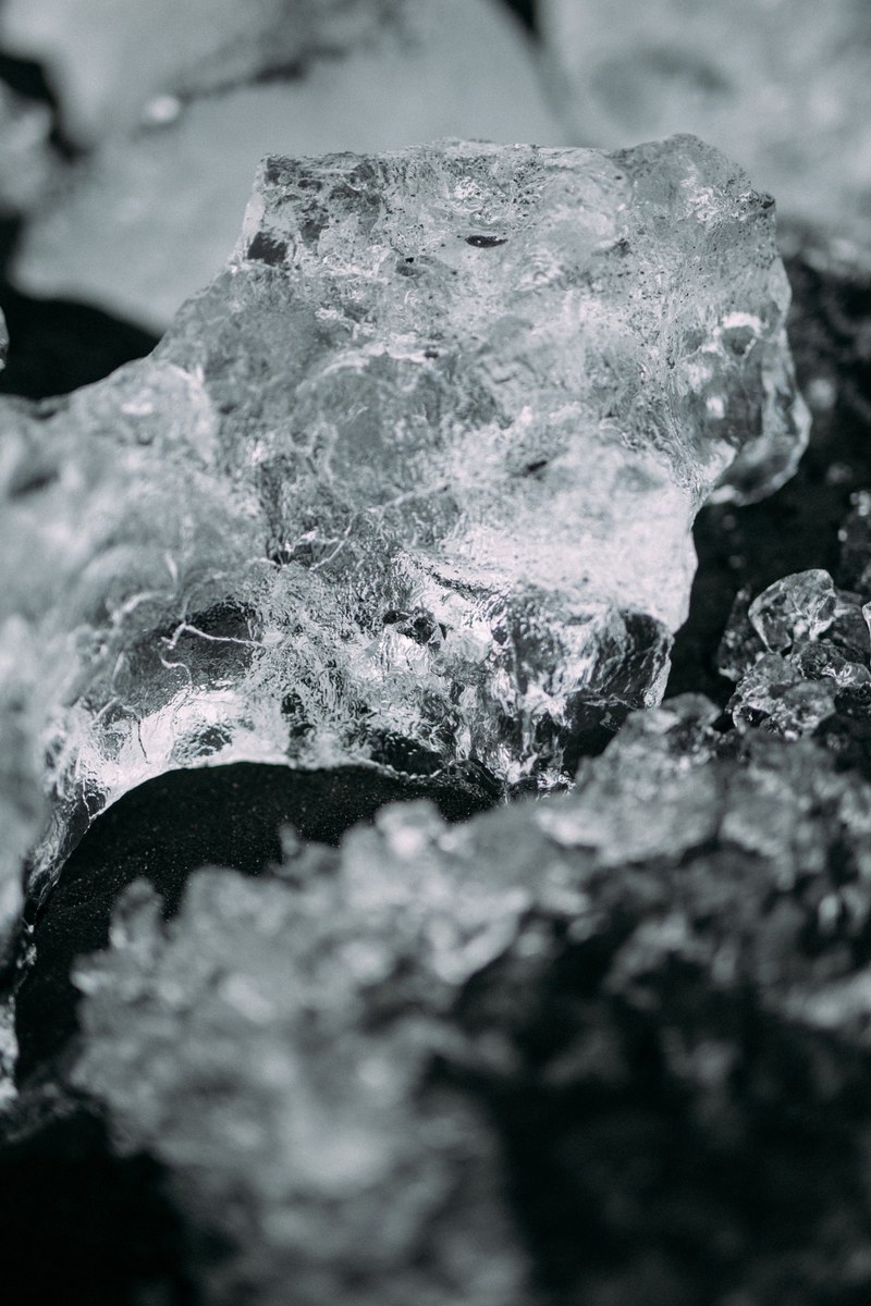 ice forms into crystal and contrasts with dark soil, ice crystal contrasting dark soil 4k