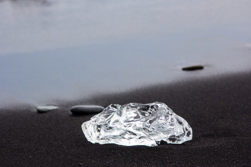 piece of ice at the jkulsrln black sand beach, ice on the beach 4k
