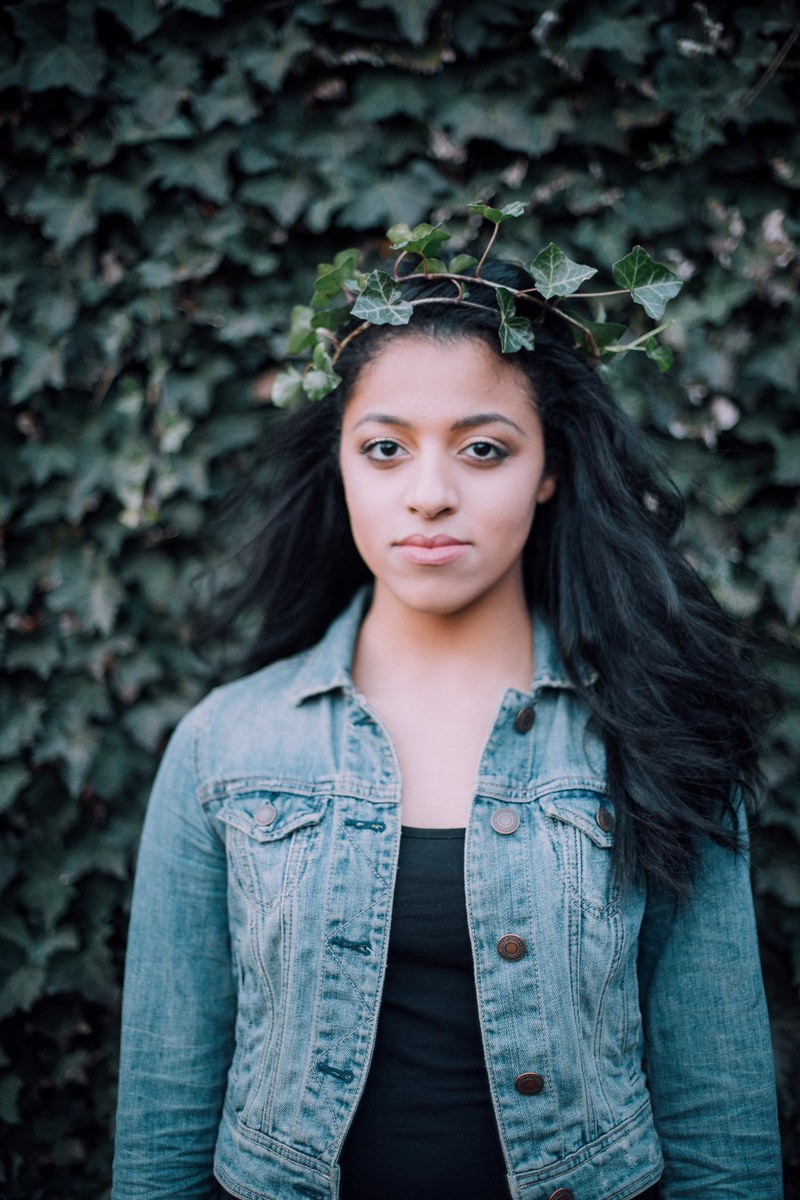 woman wearing a crown of leaves and a denim jacket, crown of leaves 4k