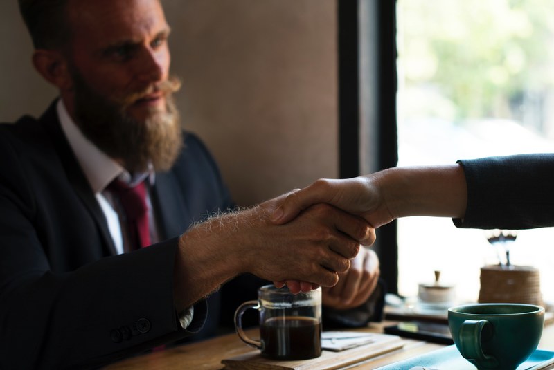a bearded man having dinner with another person shaking hands over the table, _bearded man handshake 4k