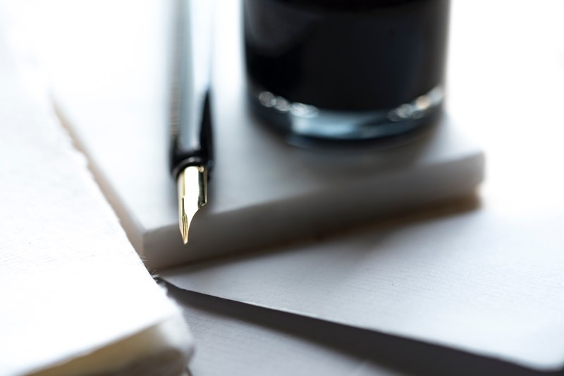 the glossy tip of a fountain pen next to a drinking glass, love of calligraphy 4k