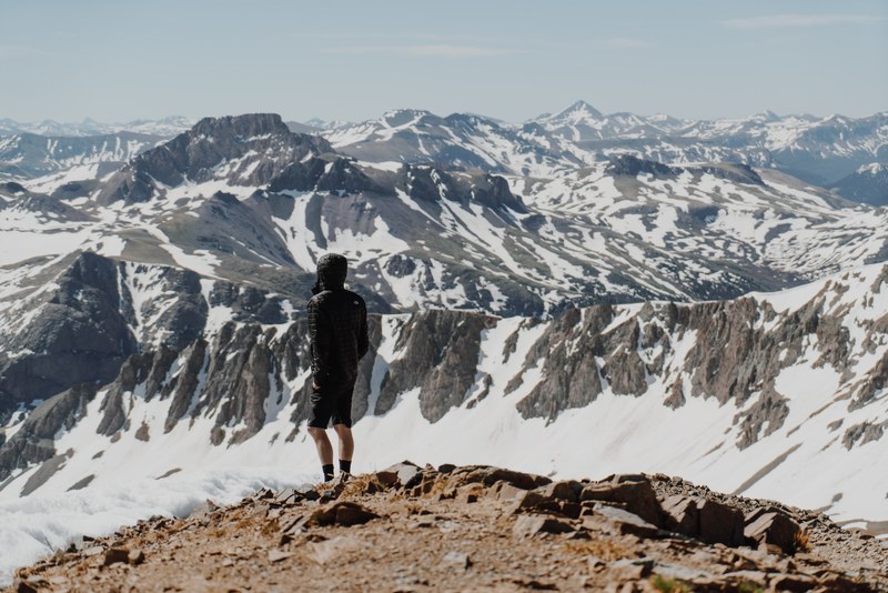 lone hiker on the summit of a mountain landscape, hiker in the mountains 4k