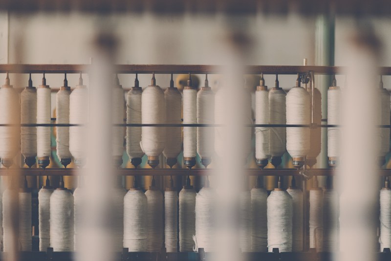 spools of white cotton threads on a machine in a factory in rydal, _white cotton threads spools 4k