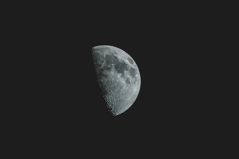 a close up view of the half moon at nelson showing the dark lunar spots, half moon at nelson 4k