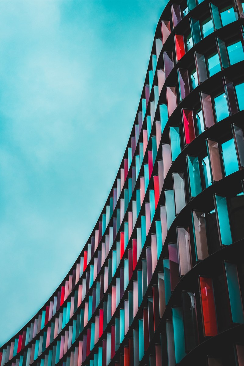 a long curved facade in blue red and purple, blue red and purple facade 4k