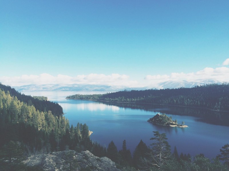 a small island on a vast lake in the mountains, island on a mountain lake 4k