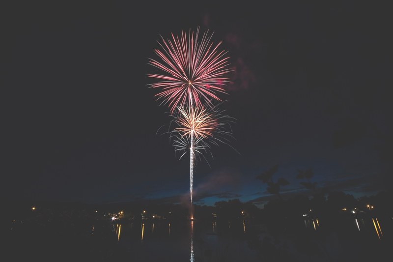 colorful fireworks over a body of water at night, fireworks over water 4k