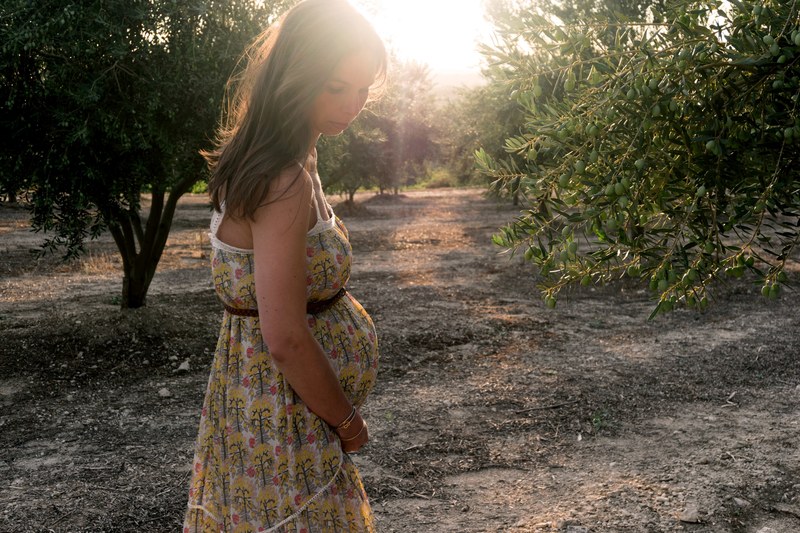 a beautiful girl in a park taking a maternity picture, _pregnant memory 4k