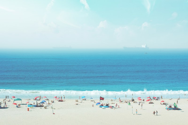crowded copacabana sand beach with a large ship on the horizon, crowded sand beach 4k